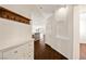 Inviting entryway featuring hardwood floors and coat rack with a shoe cabinet for convenient storage at 3597 Cherbourg Ave, Las Vegas, NV 89141