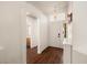 Entryway with wood-look floors, white walls, and decorative light fixture above the front door at 3597 Cherbourg Ave, Las Vegas, NV 89141