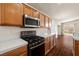 Stylish kitchen featuring an oven, a microwave, and abundant wooden cabinetry at 3597 Cherbourg Ave, Las Vegas, NV 89141