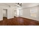 Spacious main bedroom featuring a ceiling fan, wood flooring, and natural light from two large windows at 3597 Cherbourg Ave, Las Vegas, NV 89141
