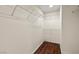 Large walk-in closet featuring lots of shelving for ample storage and wood look floors at 3597 Cherbourg Ave, Las Vegas, NV 89141