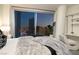 Bedroom featuring city views, soft carpets, and elegant decor at 3722 Las Vegas Blvd # 2512 E, Las Vegas, NV 89158