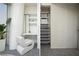Chic bedroom featuring a unique chair, built-in desk with shelving, and a custom closet organizer system at 3722 Las Vegas Blvd # 2512 E, Las Vegas, NV 89158