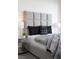 Tastefully decorated bedroom featuring a gray color scheme and glass nightstand at 3722 Las Vegas Blvd # 2512 E, Las Vegas, NV 89158