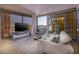 Sophisticated living room with city views, a modern TV, and stylish white furnishings at 3722 Las Vegas Blvd # 2512 E, Las Vegas, NV 89158