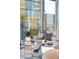 Living room detail featuring a white sofa, glass table, wine, and decor with city views at 3722 Las Vegas Blvd # 2512 E, Las Vegas, NV 89158
