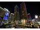 Stunning night view of the modern high-rise with illuminated signage and beautiful landscaping at 3722 Las Vegas Blvd # 2512 E, Las Vegas, NV 89158