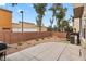 Private backyard featuring a concrete patio, low-maintenance gravel, and surrounding brick wall at 390 Clarence House Ave # 1, North Las Vegas, NV 89032