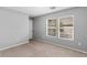 Comfortable bedroom with carpeted floors and multiple windows offering ample natural light at 390 Clarence House Ave # 1, North Las Vegas, NV 89032