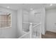 Upstairs hallway with white railing and neutral walls leading to other areas of the home at 390 Clarence House Ave # 1, North Las Vegas, NV 89032