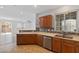 A well-lit kitchen featuring stainless steel appliances, mosaic backsplash, and an open layout at 390 Clarence House Ave # 1, North Las Vegas, NV 89032