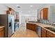 An inviting kitchen with stainless steel appliances, mosaic backsplash, and adjacent living space at 390 Clarence House Ave # 1, North Las Vegas, NV 89032