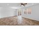 Light filled living area with tile floors, ceiling fan, sliding glass doors and two windows at 390 Clarence House Ave # 1, North Las Vegas, NV 89032
