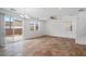 Bright living room featuring tile floors, a ceiling fan, and sliding glass doors to the patio at 390 Clarence House Ave # 1, North Las Vegas, NV 89032