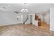 Open living room with tile flooring, ceiling fan, chandelier and staircase leading to upper level at 390 Clarence House Ave # 1, North Las Vegas, NV 89032
