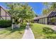 Well-maintained exterior featuring a walkway, grassy area, and mature trees at 3928 Edgemoor Way, Las Vegas, NV 89121