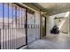 Enclosed patio area featuring an iron gate, tile flooring, and outdoor grilling space at 3928 Edgemoor Way, Las Vegas, NV 89121