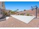 Spacious backyard features a basketball court, desert landscaping, and covered patio, perfect for entertaining at 4021 Mountain Trek St, Las Vegas, NV 89129