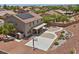 Aerial view of a backyard featuring a patio, basketball court, fire pit, and desert landscaping at 4021 Mountain Trek St, Las Vegas, NV 89129