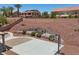 Large backyard with basketball court, fire pit, tiered landscaping, and a covered patio for outdoor entertaining at 4021 Mountain Trek St, Las Vegas, NV 89129