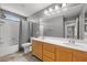 Well-lit bathroom showcasing a shower/tub combo, dual sink vanity, and tile flooring at 4021 Mountain Trek St, Las Vegas, NV 89129