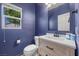 Charming powder room featuring blue walls, tile flooring, and a bright window at 4021 Mountain Trek St, Las Vegas, NV 89129