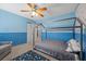 Stylish bedroom with blue walls, carpeting, and custom-built frame around the bed and a ceiling fan at 4021 Mountain Trek St, Las Vegas, NV 89129