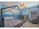 Stylish bedroom with blue walls, carpeting, and custom-built frame around the bed at 4021 Mountain Trek St, Las Vegas, NV 89129