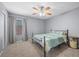 Inviting bedroom featuring neutral carpet, a ceiling fan, and a window with natural light at 4021 Mountain Trek St, Las Vegas, NV 89129