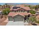 Two-story home featuring a tile roof, solar panels, attached three-car garage, and desert landscaping at 4021 Mountain Trek St, Las Vegas, NV 89129