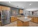 Well-lit kitchen with stainless steel appliances, tile flooring, and granite countertops on an island at 4021 Mountain Trek St, Las Vegas, NV 89129