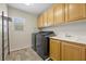 Bright laundry room features modern washer and dryer, ample cabinet space, and a convenient sink at 4021 Mountain Trek St, Las Vegas, NV 89129
