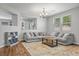 Bright living room featuring hardwood floors, a gray sofa, and modern décor at 4021 Mountain Trek St, Las Vegas, NV 89129