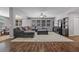 Living room featuring hardwood floors, a large sectional sofa, and entertainment center at 4021 Mountain Trek St, Las Vegas, NV 89129