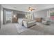 Large main bedroom with neutral walls, carpet, and a seating area at 4021 Mountain Trek St, Las Vegas, NV 89129