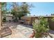 Lush backyard area featuring a brick patio, mature plants, and outdoor seating at 4027 Maple Hill Rd, Las Vegas, NV 89115