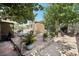 A brick patio and lush foliage enhance the backyard, offering a perfect blend of relaxation and natural beauty at 4027 Maple Hill Rd, Las Vegas, NV 89115