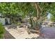 Spacious backyard with brick patios, mature trees, and lush greenery, offering a peaceful retreat at 4027 Maple Hill Rd, Las Vegas, NV 89115