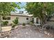 Private backyard featuring a brick patio area with mature trees, perfect for outdoor entertaining at 4027 Maple Hill Rd, Las Vegas, NV 89115