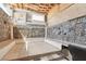 Basement space with stone-clad walls, open ceiling, and tiled flooring at 4027 Maple Hill Rd, Las Vegas, NV 89115
