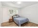 Bedroom with wood floors, white walls, and natural light from the window at 4027 Maple Hill Rd, Las Vegas, NV 89115