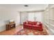 Bright living room featuring hardwood floors, built-in bookshelves, and a decorative rug at 4027 Maple Hill Rd, Las Vegas, NV 89115