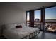 Bright bedroom with hardwood floors and expansive windows overlooking the city at night at 4471 Dean Martin Dr # 2406, Las Vegas, NV 89103