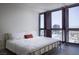 Bright bedroom featuring a modern bed frame, natural light, and impressive city views at 4471 Dean Martin Dr # 2406, Las Vegas, NV 89103
