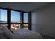 Serene bedroom with floor-to-ceiling windows offering views of the city skyline at dusk at 4471 Dean Martin Dr # 2406, Las Vegas, NV 89103