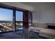 Cozy living room with plush seating and stunning city views through expansive windows at 4471 Dean Martin Dr # 2406, Las Vegas, NV 89103