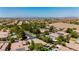 Expansive aerial view of a neighborhood in Las Vegas with single-Gathering homes, mature trees, and community streets at 4493 Rometta Ave, Las Vegas, NV 89141