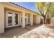 View of back patio area with multiple sets of doors and desert landscaping at 4493 Rometta Ave, Las Vegas, NV 89141