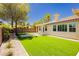 Landscaped backyard with putting green, artificial grass, and desert landscaping at 4493 Rometta Ave, Las Vegas, NV 89141