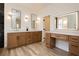 Bright bathroom with dual sinks, modern mirrors, and a vanity with a makeup station at 4493 Rometta Ave, Las Vegas, NV 89141